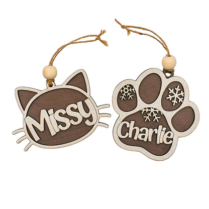 Two wooden ornaments shaped like a cat face and a paw print with names 'Missy' and 'Charlie'.