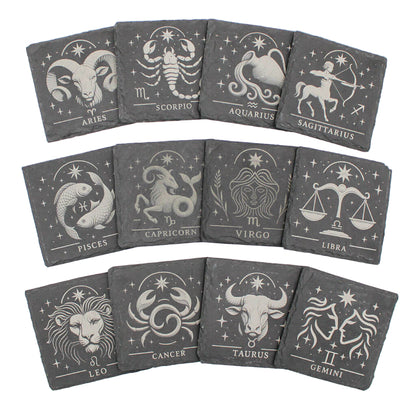 Set of twelve gray coasters with zodiac symbols on a white background
